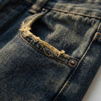 Detalje af den vaskede vintage-finish på baggy jeansene