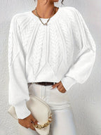Afslappet kabelstrikket sweater, set bagfra
